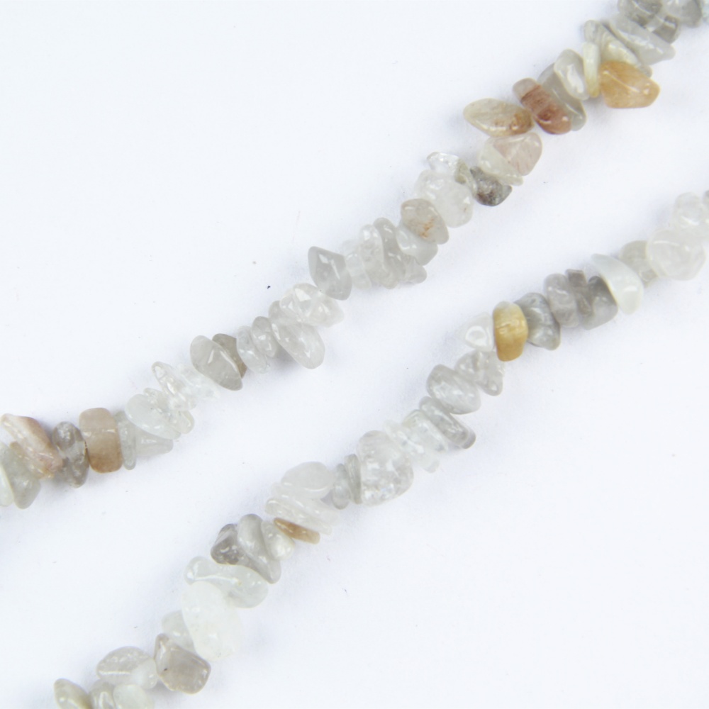 Add depth and elegance to your jewelry with these Rutilated Quartz Chip Beads. The 5-8mm chips feature natural golden or silver rutile strands, perfect for creating striking jewelry pieces like necklaces, bracelets, and earrings that stand out.