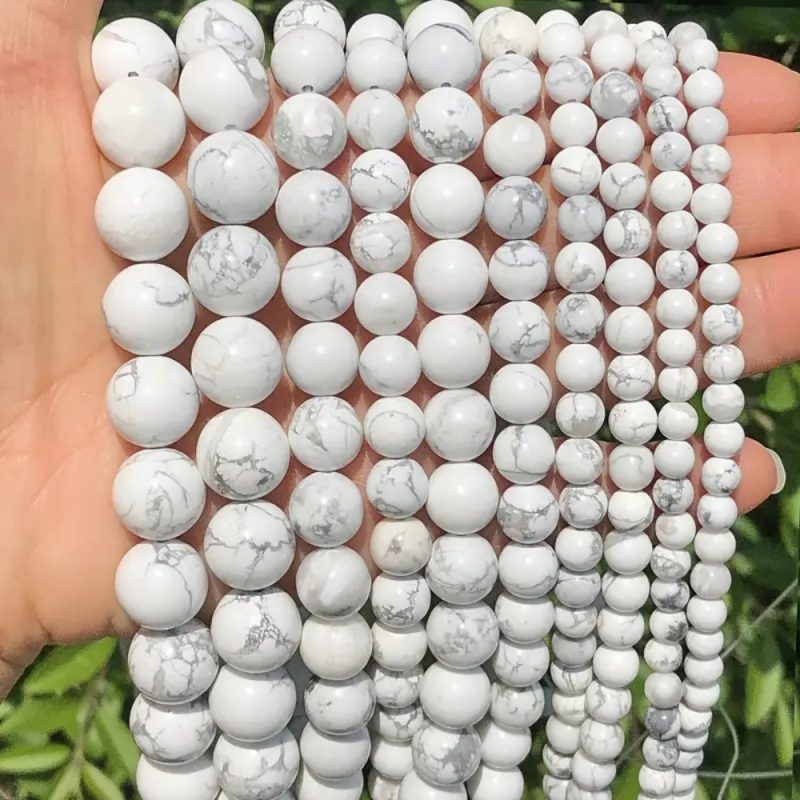 This unique strand features Natural White Howlite beads in a beautifully varied size range of 6-12mm. The 40cm (~16 inch) strand includes smooth, round beads that graduate in size, creating natural visual interest and dynamic texture. Howlite's signature milky white color with subtle grey veining is showcased across each bead, offering a serene and elegant palette. Perfect for designers who want to create jewelry with organic flow, dimension, and a touch of minimalist sophistication without needing to sort multiple strands.