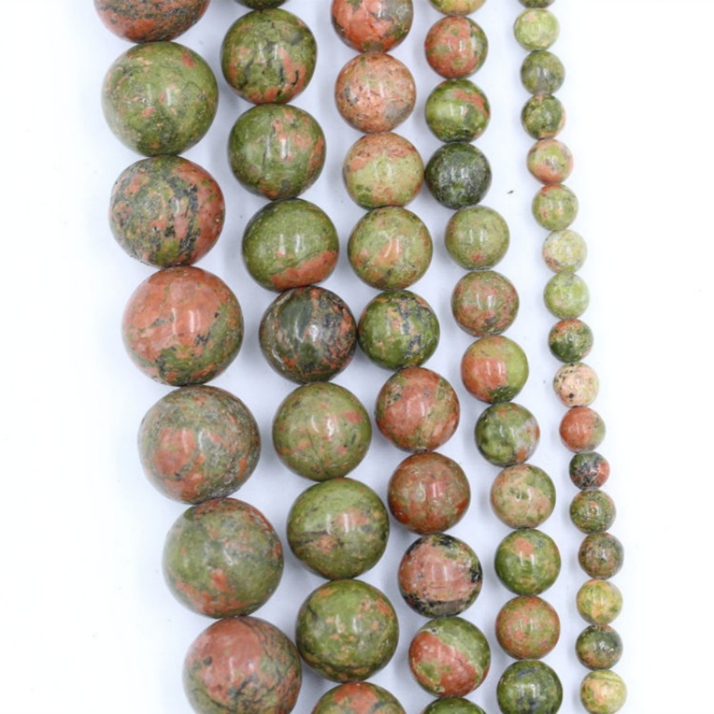 Round Unakite Beads (4-12mm) in earthy pink and green tones, perfect for creating unique jewelry pieces.