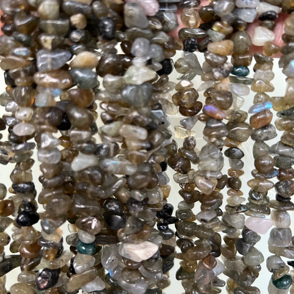 Natural Labradorite gemstone chip beads, irregular tumbled shapes, perfect for layered necklaces, bracelets, and handmade jewelry.