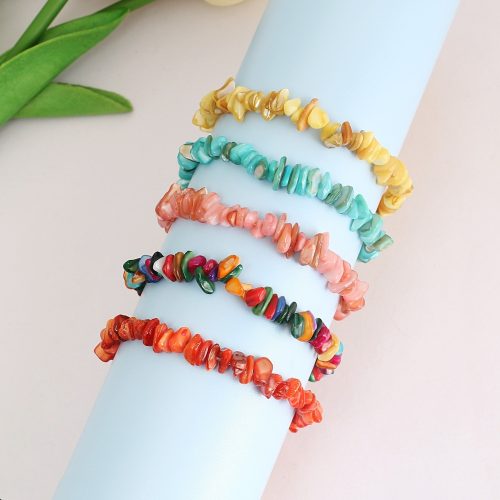 Pile of multicolored shell chip bracelets, similar to healing crystal bracelets with boho stretch design.